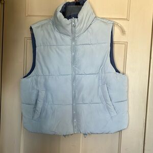Size M cropped puffer vest, reversible pale blue with darker blue on inside.